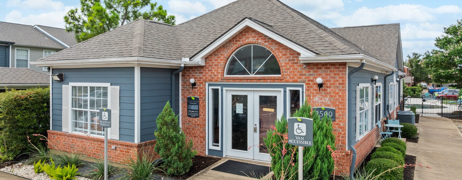 a brick building with a sign in front of it