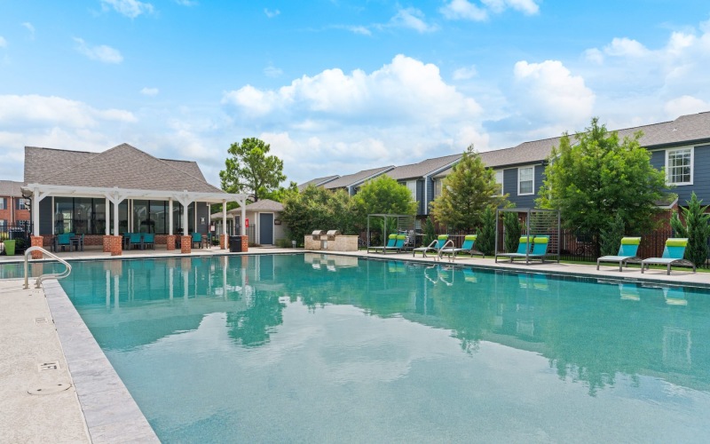 a swimming pool with chairs around it