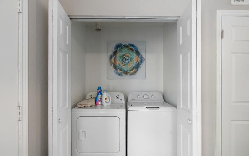 a laundry closet with a washer and dryer