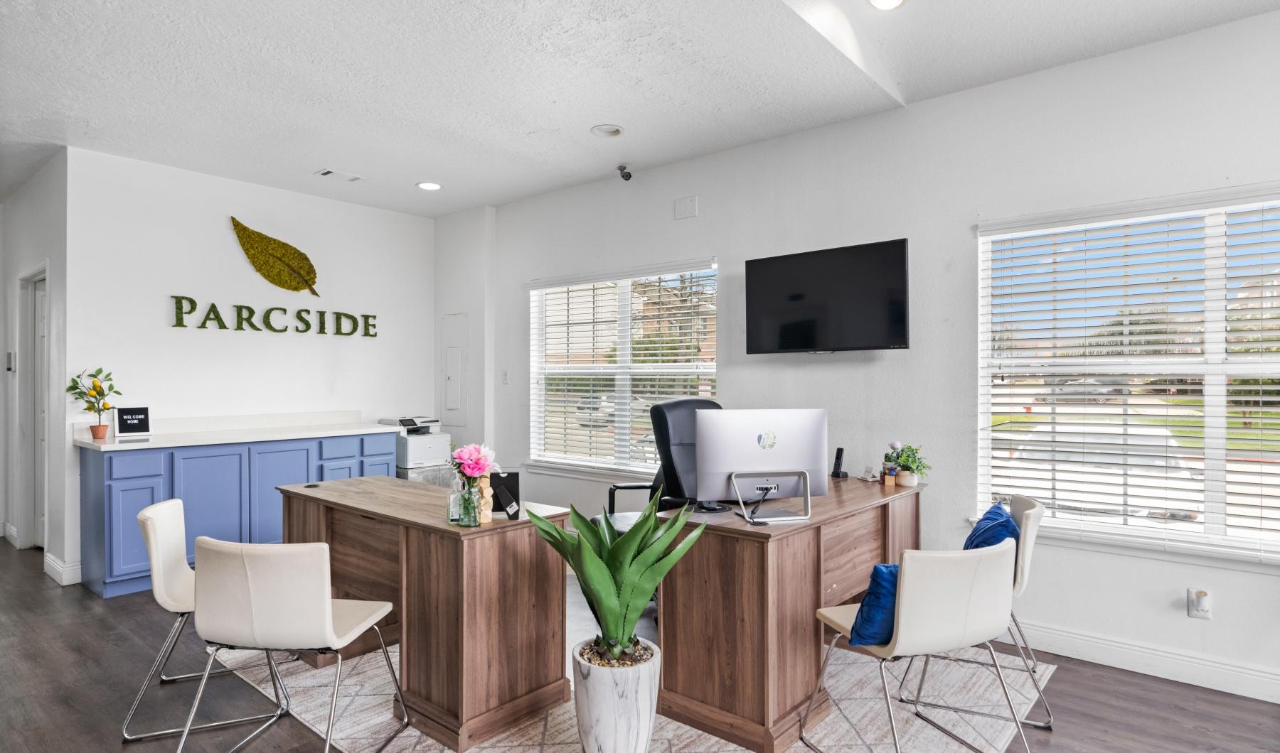 a leasing office with a desk and chairs